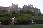 Start of the cycling during the Bamburgh Triathlon with Bamburgh Castle as a backdrop with heavy rain falling